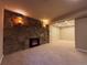Finished basement with carpet, a stone fireplace, sconces, and access to another room at 2357 E Mineral Ave, Centennial, CO 80122