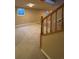 Finished basement with carpet, staircase, railing, and multiple windows at 2357 E Mineral Ave, Centennial, CO 80122