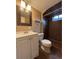 Bathroom featuring dark tile shower and vanity at 2357 E Mineral Ave, Centennial, CO 80122