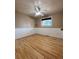 Bedroom featuring hardwood floors, neutral paint, and a large window at 2357 E Mineral Ave, Centennial, CO 80122