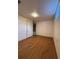 Bedroom with hardwood floors and view into hallway at 2357 E Mineral Ave, Centennial, CO 80122