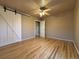 Spacious bedroom with hardwood floors, ceiling fan and a sliding barn door at 2357 E Mineral Ave, Centennial, CO 80122
