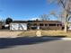 Charming brick home featuring an attached two-car garage and mature trees in the front yard at 2357 E Mineral Ave, Centennial, CO 80122