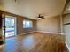 Bright living room featuring hardwood floors, ceiling fan, and large windows at 2357 E Mineral Ave, Centennial, CO 80122