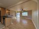 Open-concept living room with hardwood floors, a ceiling fan, and seamless access to the kitchen at 2357 E Mineral Ave, Centennial, CO 80122