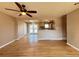 Open-concept living room with hardwood floors, a ceiling fan, and seamless access to the kitchen at 2357 E Mineral Ave, Centennial, CO 80122