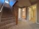 Carpeted staircase leading to a room with multiple doorways and wood trim at 2357 E Mineral Ave, Centennial, CO 80122