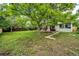 Spacious backyard featuring a mature tree offering shade, and a deck perfect for outdoor relaxation at 3111 Troy St, Aurora, CO 80011