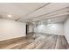 Spacious basement with wood-look floors and neutral walls, offering ample room for storage or recreation at 3111 Troy St, Aurora, CO 80011