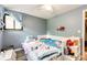 bedroom with twin beds, blue curtains, and playful decor at 3111 Troy St, Aurora, CO 80011