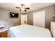 Bedroom with white bedframe, wood floors, a TV, and closet at 3111 Troy St, Aurora, CO 80011