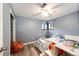 bedroom with twin beds, blue curtains, and playful decor at 3111 Troy St, Aurora, CO 80011