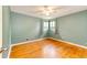 Simple bedroom featuring hardwood floors, a window, and neutral walls at 3111 Troy St, Aurora, CO 80011