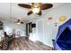 Bright bonus room featuring ceiling fans, access to the backyard, and play area at 3111 Troy St, Aurora, CO 80011