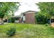 Charming two-story home featuring a brick facade, lush lawn, and mature trees at 3111 Troy St, Aurora, CO 80011