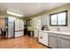 A cozy kitchen with wood floors, modern appliances, and an exterior door at 3111 Troy St, Aurora, CO 80011