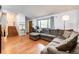 Comfortable living room with hardwood floors, large sectional sofa and staircase at 3111 Troy St, Aurora, CO 80011