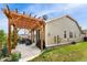 View of the backyard featuring a pergola, outdoor seating, a grill, and a well-maintained lawn at 6046 Gilbert Way, Golden, CO 80403