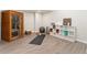 Basement with sauna and yoga space, featuring modern gray wood flooring and shelving for storage at 6046 Gilbert Way, Golden, CO 80403