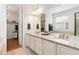 Bright bathroom with double vanity, granite countertops, and a walk-in closet at 6046 Gilbert Way, Golden, CO 80403
