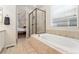 Primary bathroom with separate tub and shower, neutral tones, and natural light at 6046 Gilbert Way, Golden, CO 80403