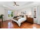 Spacious primary bedroom with tray ceilings, hardwood floors, and large windows with view to yard at 6046 Gilbert Way, Golden, CO 80403