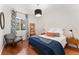 Bedroom with window and side tables with modern decor and light fixture at 6046 Gilbert Way, Golden, CO 80403