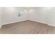 Empty bedroom with light gray floors, white walls, and a window at 6046 Gilbert Way, Golden, CO 80403