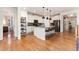 Modern kitchen featuring an island with bar seating, stainless steel appliances, and hardwood floors at 6046 Gilbert Way, Golden, CO 80403