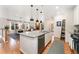 Open-concept kitchen island with granite countertops, stainless steel appliances, and bar seating, perfect for entertaining at 6046 Gilbert Way, Golden, CO 80403