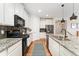 Well-equipped kitchen with granite countertops, stainless steel appliances, and a gas range for culinary enthusiasts at 6046 Gilbert Way, Golden, CO 80403