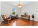 Bright office space with hardwood floors, stylish light fixture, and a modern desk with a large window view at 6046 Gilbert Way, Golden, CO 80403