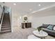 Finished basement featuring a modern wet bar, plush carpeting, comfortable sofa, and staircase access at 1715 Grove St, Denver, CO 80204