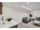 A stylish basement area featuring a wet bar, comfortable seating, and modern decor with plants for design at 1715 Grove St, Denver, CO 80204