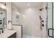 Modern bathroom featuring a spacious glass shower with dark fixtures and a light tiled wall at 1715 Grove St, Denver, CO 80204