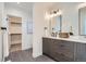 Beautiful bathroom with double vanity, stone countertops, and a large mirror, plus an open walk-in closet at 1715 Grove St, Denver, CO 80204