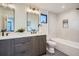 Modern bathroom showcases a double sink vanity, sleek mirrors, and a tub/shower combination at 1715 Grove St, Denver, CO 80204