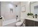 A contemporary bathroom featuring a tub, sleek toilet, and stylish tiling with light walls at 1715 Grove St, Denver, CO 80204