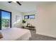 Bright bedroom with a bench, modern art, and large glass door leading to an outdoor area at 1715 Grove St, Denver, CO 80204