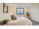 Well-lit bedroom featuring a neutral palette, plush carpet, and a large window at 1715 Grove St, Denver, CO 80204