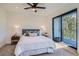 Stylish bedroom features a ceiling fan, a glass door to a balcony, and modern bedside tables at 1715 Grove St, Denver, CO 80204