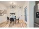 Open dining area features modern lighting and a round glass table set for four at 1715 Grove St, Denver, CO 80204