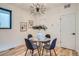 Bright dining room features a glass table, modern light fixture, and neutral wall art at 1715 Grove St, Denver, CO 80204