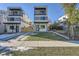 Modern two-story home featuring a balcony, manicured lawn, and contemporary design elements at 1715 Grove St, Denver, CO 80204