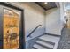 A clean exterior entrance showing modern steps and a partial view of an interior dining area at 1715 Grove St, Denver, CO 80204