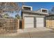 The rear exterior of a two-car garage with wooden fence and gate, plus 'No Parking' sign at 1715 Grove St, Denver, CO 80204