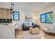 Bright living area with hardwood floors, modern decor, and a view into the kitchen at 1715 Grove St, Denver, CO 80204