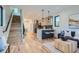 Open-concept living area with hardwood floors, modern kitchen, staircase, and stylish decor at 1715 Grove St, Denver, CO 80204