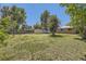 Expansive backyard with a well-kept lawn, providing ample space and showcasing a shed for storage at 1750 S Dale Ct, Denver, CO 80219