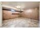Spacious basement with paneled walls, drop ceiling, and unique patterned flooring, ready for customization at 1750 S Dale Ct, Denver, CO 80219